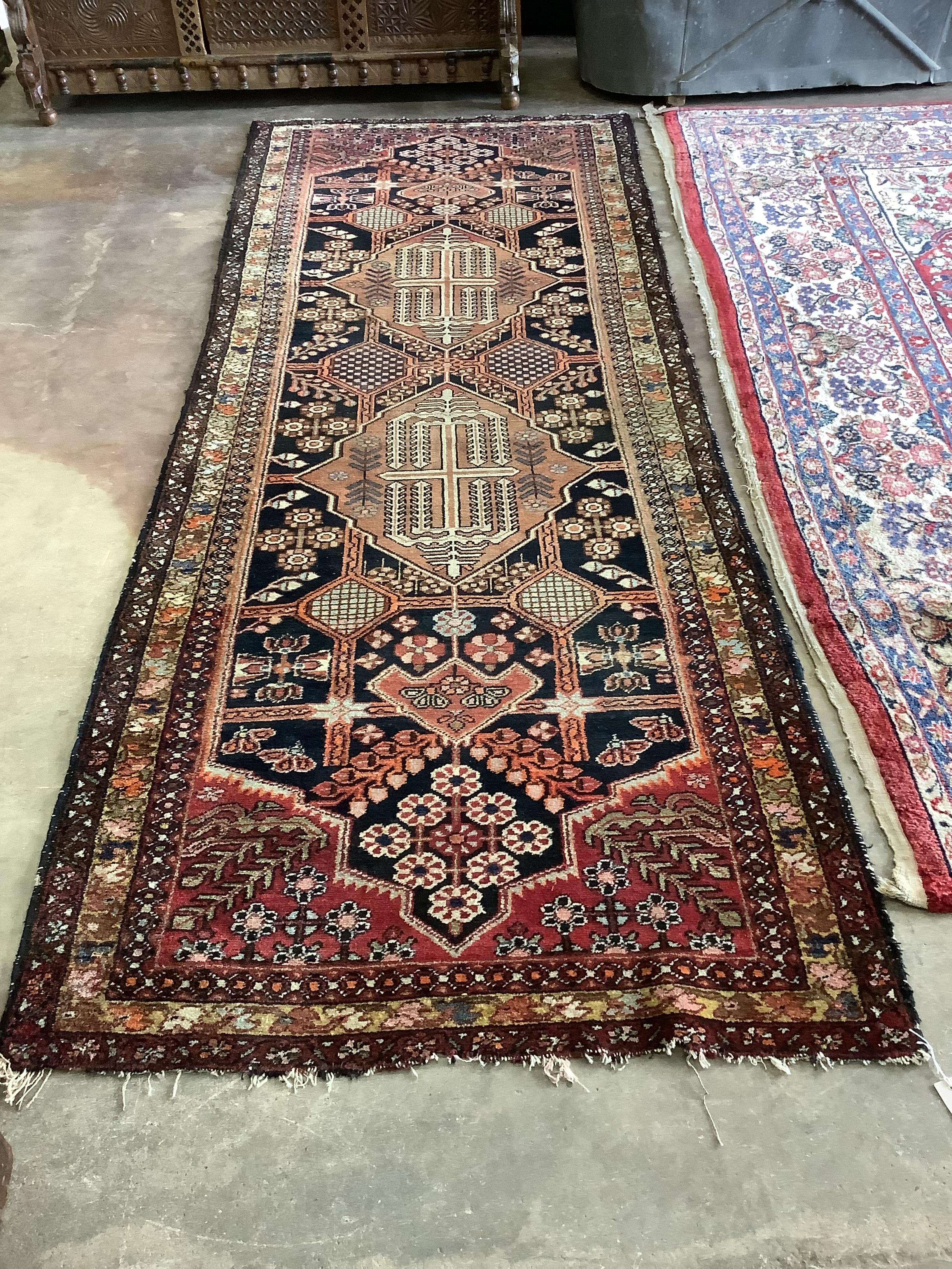 An antique Turkish blue ground geometric runner, 290 x 106cm